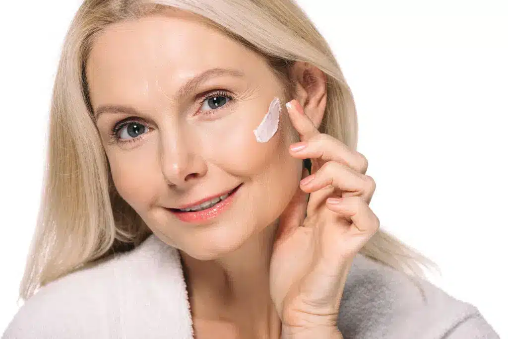 smiling mature woman applying cosmetic cream isola 2021 08 29 17 02 27 utc 1 1024x683.jpg