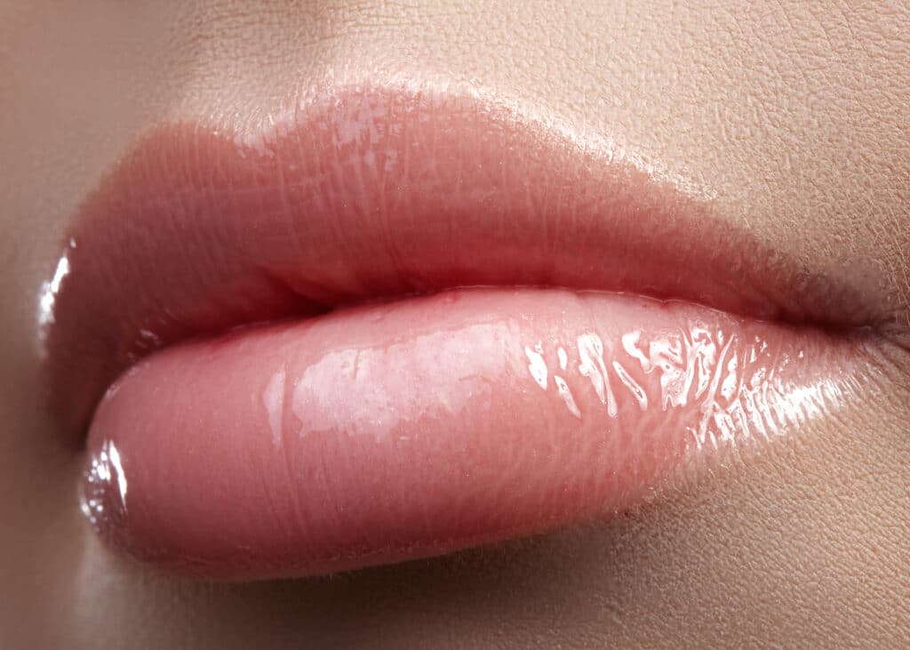 Close up of woman’s pink, full lips from BOTOX lip flip in Sarasota, FL.