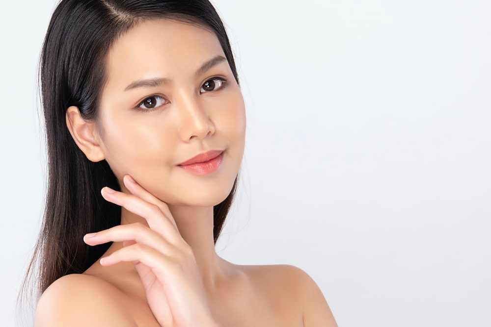 Beautiful Young Asian Woman with Clean Fresh Skin. Face care, Facial treatment