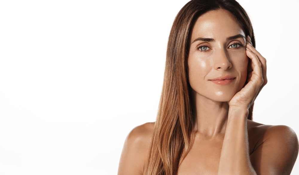 Woman with radiant, glowing skin and a hydrated complexion, showcasing the rejuvenating results of a HydroFacial treatment after a spa or cosmetic skincare procedure.