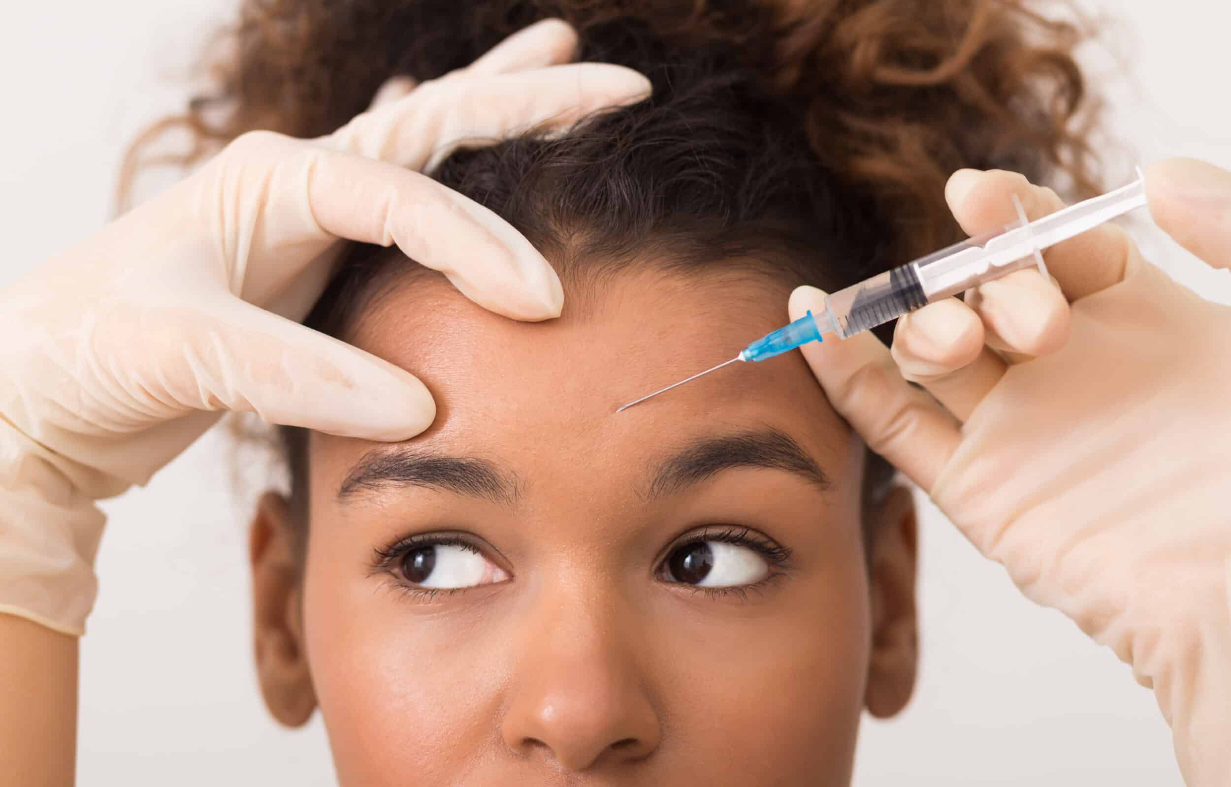 Close-up of gloved hand holding a syringe, concept of medical injection and clinical treatment